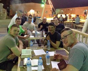 Airmen at Al Udeid Air Base in Qatar study Luther’s Small Catechism and tend to cigars during one of their “Holy Smokes” Bible studies.