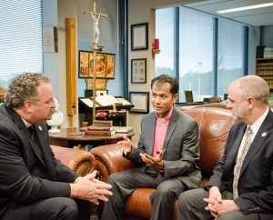 The Rev. Vannarith Chhim (center), president of the five-year-old Evangelical Lutheran Church of Cambodia (ELCC), talks with LCMS President Rev. Dr. Matthew C. Harrison (left) and Darin Storkson, senior regional director for Asia with the LCMS Office of International Mission, during a Sept. 12 visit to the Synod's International Center in St. Louis. The three signed a protocol agreement that details how the ELCC, LCMS and Lutheran Church—Canada will work together in Cambodia over the next three years. (LCMS/Frank Kohn)