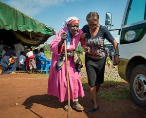 LCMS career missionary Shara Cunningham, right, assists a woman to a van for transport to a hospital June 12 in Kakmega County, Kenya. The Synod is hoping to place at least 45 new missionaries — church professionals, health workers and laity — in Africa by summer 2015. (LCMS/Erik M. Lunsford)