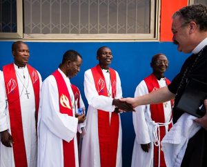 LCMS President Rev. Dr . Matthew C. Harrison greets seminarians Feb. 2 before the dedication of new facilities for the Lutheran Theological Seminary of the Evangelical Lutheran Church of Ghana. At the Sept. 29-30 meeting of the LCMS Board for International Mission, Bishop Christian Ekong of the Lutheran Church of Nigeria said that theological education is one of the most important areas with which the LCMS can help in Africa. (LCMS/Erik M. Lunsford) 