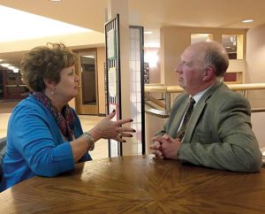 The Rev. Steven Sutterer, a chaplain for Sparrow Hospital in Lansing, Mich., visits with a friend of a patient in that hospital. The LCMS Board for National Mission decided at its Sept. 26-27 to extend a call — its first ever — to Sutterer. (Martha Sutterer)