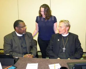 Board for National Mission (BNM) Vice-Chairman Rev. Samuel Cosby, left, welcomes new board members Deaconess Shaina M. Mitchell and the Rev. Timothy J. Droegemueller to the board at its Sept. 26-27 meeting in St. Louis. (LCMS/Joe Isenhower Jr.)  