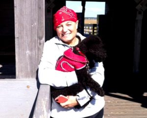 Maggie Karner poses with her dog, Moose, at Hammonasset Beach in Connecticut Oct. 9. Karner, director of LCMS Life and Health Ministries, says of her brain-cancer journey: "circumstances out of my control are not the worst thing that can happen to me. The worst thing would be losing faith, refusing to trust in God’s purpose in my life and trying to grab that control myself."