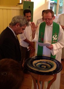 The Rev. Hugo Gevers prays for Eizadi Shahriyar during the German and Farsi Baptismal Rite July 27 at St. Trinitatisgemeinde (Holy Trinity Lutheran Church) in Leipzig. (St. Trinitatisgemeinde)