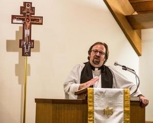 The Rev. Kurt Onken, pastor of Messiah Lutheran Church, Marysville, Wash., preaches during a special Oct. 27 service of healing attended by more than 100 people, including the congregation's high-school students and their families. (Tony Cataldo)