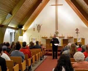 The Rev. Ron Norris, district disaster response coordinator for the LCMS Northwest District and an emergency-services chaplain, addresses worshipers after an Oct. 27 healing service at Messiah Lutheran Church, Marysville, Wash. (Richard Martin/Lutheran Church Charities)