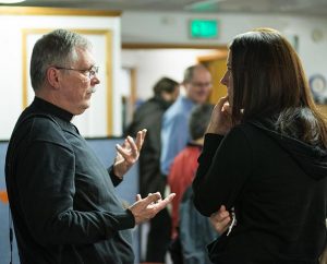 The Rev. Ron Norris, district disaster response coordinator for the LCMS Northwest District and an emergency-services chaplain, talks with Jackie Nolte after the Oct. 27 worship service at Messiah Lutheran Church in Marysville, Wash. Nolte is the mother of 14-year-old Peyton Nolte, an eyewitness to the shooting. (Tony Cataldo)