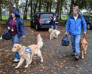 Lutheran Church Charities (LCC) K-9 Comfort Dogs arrive at a site in Marysville, Wash., after the shooting that killed five students at Marysville-Pilchuck High School on Oct. 24. From left are Jeanne Moore with Aaron, Toni Bazon with Shami and Tom Bartnick with Luther. Nearly 40 LCMS churches and schools in 16 states now have their own comfort dogs from Addison, Ill.-based LCC. (Ron Norris)