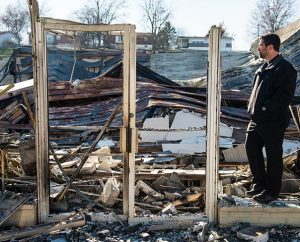 The Rev. Ross Johnson, director of LCMS Disaster Response, surveys the burned-out shell of the Family Dollar store on Halls Ferry Road in St. Louis. Protesters in Ferguson are angrier than they were when Michael Brown was shot, but that's all the more reason for "God's ambassadors" to be there, Johnson said: "People need to see that the church is present in times of turmoil." (LCMS/Erik M. Lunsford)