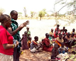 LCMS Missionary Shara Cunningham introduces herself to the Samburu people in Sirata, Kenya, Oct. 3 with the help of local evangelist Richard Lewaseiyan. (LCMS/Phil Jaseph)