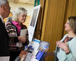 At the Lutherans For Life (LFL) exhibit for its 2015 national conference in Grand Rapids, Mich., LFL Data Analyst Jerilyn Richard, right, shares information about the organization with Rev. Lyndon and Linda Kohomen of Minneapolis. (Michael Schuermann)