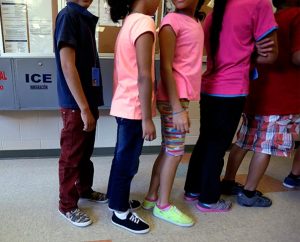 Detained immigrant children line up in the cafeteria at the Karnes County Residential Center, a temporary home for immigrant women and children detained at the border, in Karnes City, Texas, on Sept. 10. A "roundtable" meeting on the exodus of children and families from Central America brought together Lutheran leaders from the U.S., Guatemala, Honduras, El Salvador, Mexico and Nicaragua; representatives from various partner organizations involved in the response to the current immigration crisis; and regional experts. (AP Photo/Eric Gay)