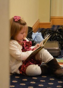 Charlotte Loemker entertains herself while her father, Chris Loemker, explains to LCMS Rural and Small-Town Mission conference attendees how to encourage musicianship and music literacy in small churches. (LCMS/Adriane Heins)