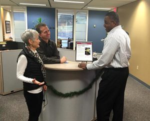 From left, Concordia Plan Services (CPS) employees Maureen Schneider, Steve Gruenwald and Louis Johnson admire a framed copy of the St. Louis Business Journal article announcing CPS as a “St. Louis Healthiest Employer” for 2014 — the third consecutive year that CPS has been chosen for the distinction.