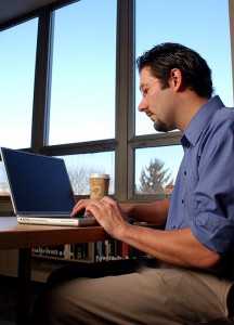 Brett Seider, a graduate student in the Information Technology program at Concordia University Wisconsin, Mequon, studies in the school library. The university has been recognized as a national and statewide leader for three of its online master's degree programs.