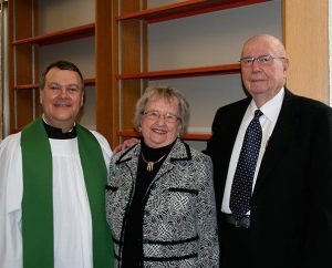 Concordia Theological Seminary, Fort Wayne, Ind., President Rev. Dr. Lawrence R. Rast Jr., left, poses with Barbara and Wayne Kroemer, who were instrumental in the expansion of the seminary's library and for whom the library is named. (Colleen Bartzsch/Concordia Theological Seminary)