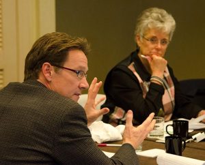 LCMS Task Force on Domestic Violence and Child Abuse member Dr. Stephen Saunders explains a point at the Jan. 30 task force meeting in St. Louis. In the background is parish nurse and task-force member Karen Hardecopf. (LCMS/Frank Kohn)