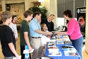 Participants at the 2014 Society of Creation conference in Mequon, Wis., check out resources on creationism. This year's conference is set for July 6-8 in Ann Arbor, Mich. (Gary Locklair)