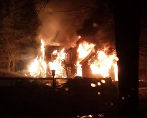 An early-morning fire engulfs the Taunton, Mass., home of the Rev. Ingo Dutzmann on March 11. The LCMS pastor says "it's a God thing" as an explanation for how all five members of the family escaped unharmed. (Courtesy of the Dutzmann family)