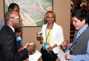 Concordia College Alabama, Selma, students Bruktawit Alemu Shetta (center) and Tri Lan (right) visit with Glenn King Jr. (left), division chair of the college's Business and Integrated Computer Systems, and business professor Dr. Tawonga Moyo at the LCEF National Student Marketing Competition awards dinner, April 10 in St. Louis. (Lutheran Church Extension Fund)