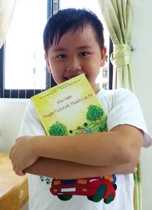 Eight-year-old Danny holds his copy of A Child's Garden of Bible Stories, in Vietnamese, which he has read again and again. An LWML grant of $72,000 is being used by the Lutheran Heritage Foundation to translate and publish that book and Luther's Small Catechism in the languages of Southeast Asia. A total of 26,000 copies have so far been distributed in Indonesia, Laos, Myanmar, Thailand and Vietnam, and among Hmong communities in the United States. (Lutheran Heritage Foundation)