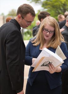 Concordia Seminary, St. Louis, second-year student Andrew Johnson reviews details of his upcoming vicarage with his wife, second-year deaconess student Tiffany Johnson, after the seminary’s April 29 vicarage-assignment service.  His assignment is with St. Luke’s Lutheran Church, Oviedo, Fla. Tiffany also was assigned as a deaconess intern with the same congregation. (Concordia Seminary, St. Louis/Jill Gray) 