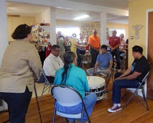 The Rev. Will Main (at left, seated) joins other participants in a Native American “honor ceremony” for Lutheran Church Extension Fund’s Laborers For Christ this spring when work resumed on the new Haskell LIGHT Campus Ministry Center in Lawrence, Kan. (Haskell LIGHT Campus Ministry)