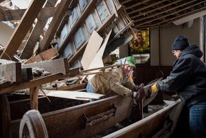 Church members work to salvage cherished items from Zion Lutheran Church on May 11, 2015, in Delmont, S.D. A tornado swept through the area on Sunday and destroyed the church along with nearby buildings. (LCMS/Erik M. Lunsford)