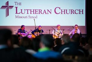 LCMS President Matthew C. Harrison (left) joins the band 'Old School’ for a concert at the Stadthaus on Saturday, May 2, 2015, in Wittenberg, Germany. Band members (L-R) the Rev. Russell Tkac, pastor at Peace Lutheran Church, Waterford, Mich., Rob Bourassa of Wyandotte, Mich., and Ross Holmes, who grew up attending Christ Lutheran Church in Fort Worth, Texas, and who currently resides in Nashville, Tenn, join President Harrison. The band ‘Lost and Found’ also played at the concert following ‘Old School.' (LCMS/Erik M. Lunsford)