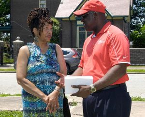 College Hill resident and community leader Carol Crenshaw chats with Fred Kimbrough, Lutheran Housing Support director of Projects and Lending, after the College Hill Peace and Praise Walk June 6. (James H. Heine)