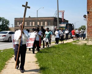 The Rev. Edward Watson, pastor emeritus of St. Paul Lutheran Church, College Hill, leads one of two groups participating in Lutheran Housing Support’s Peace and Praise Walk in the College Hill community June 6. (James H. Heine)