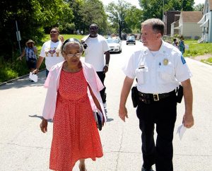 St. Louis Metropolitan Police Department Sixth District Commander Capt. Kenneth Kegel walks with Ida Odom during Lutheran Housing Support’s Peace and Praise Walk June 6. (James H. Heine)