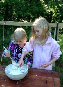 Campers at Christ Serve Ranch prepare dough for baking biscuits in a Dutch oven. The camp will offer free tours, demonstrations, presentations and meals during its Aug. 28-30 dedication weekend. (Judy Kretzschmar)