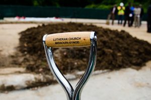 The Lutheran Church—Missouri Synod — noted on the handle of the shovel used by the Rev. Steven Schave at the recent groundbreaking — is one of four partners that will offer services at the new Community Empowerment Center of Ferguson, to open in summer 2016. (LCMS/Frank Kohn)