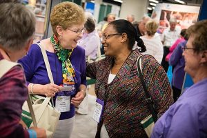 Lois Pohlmann, left, and Tadelech Loha Shumbio greet each other in the exhibit hall of the 36th Biennial Convention of the Lutheran Women's Missionary League in Des Moines, Iowa. (LCMS Communications/Erik M. Lunsford)