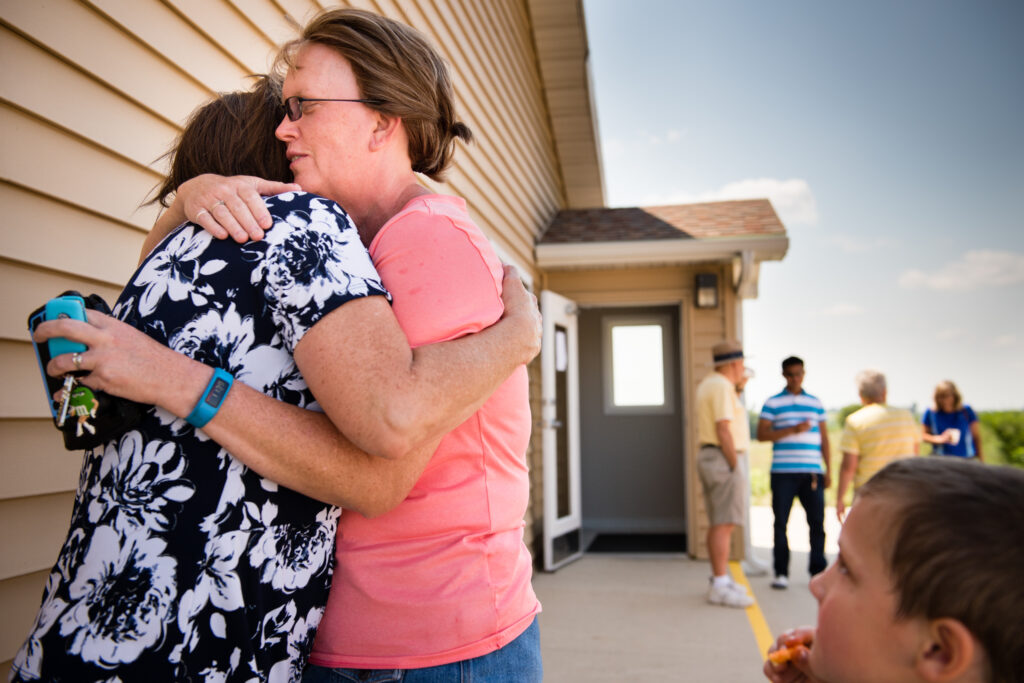Mindy Kaufman and Waunita Watt (facing camera) hug during the grand opening of the Iowa Life Care (LC) Clinic on Saturday, Aug. 15, 2015, in Creston, Iowa. The clinic is a former Planned Parenthood facility. LCMS Communications/Erik M. Lunsford