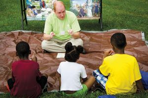 The Rev. Adam Filipek, pastor of Salem Lutheran Church in nearby Black Jack, Mo., shares a Bible story with children. (LCMS/Frank Kohn)