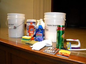 Among the contents of a typical "flood bucket" — on display at the conference — are bleach and other cleaners, paper towels, a scrub brush, sponges, disposable gloves and towels. Flood buckets — used for cleanup — should always have a lid to prevent items from spilling out. (LCMS/Paula Schlueter Ross)