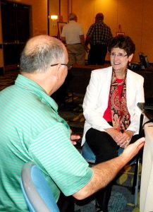 Dr. Beverly Yahnke talks to a conference-goer after her presentation on "Child-size Trauma." Yahnke, executive director for Christian Counsel with DOXOLOGY: The Lutheran Center for Spiritual Care and Counsel, said staying with a child during a disaster is important. Tell the child you're there to help, she said, and point out the other helpers, such as police officers and firemen. (LCMS/Paula Schlueter Ross)