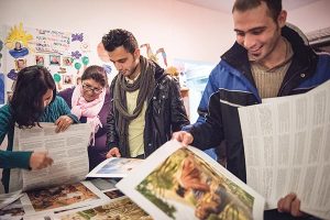 Iranian refugees pick out posters from Concordia Publishing House following a Bible study on Friday, Nov. 13, 2015, near the Evangelisch-Lutherische St. Trinitatisgemeinde, a SELK Lutheran church in Leipzig, Germany. (LCMS/Erik M. Lunsford)