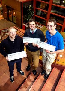 Holding their $300 checks as first-place winners in the Chicago IEEEXtreme 24-Hour Programming Competition are, from left, Andrew Menke, Joseph Bayer and Nicholas Farley, Concordia University Chicago undergraduates who made up the winning team. (Concordia University Chicago/Emily Barrett)