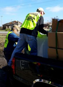 Disaster response volunteers from the LCMS Texas District and Synod congregations pick up debris from the Dec. 26 tornadoes. “People are sacrificing personal time in a desire to relieve the pain and confusion that results from such overwhelming devastation — all in the name of Christ,” said the Rev. Steven Misch, the district's disaster response coordinator. (David Ricks)