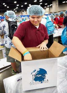 A participant at the 2013 LCMS Youth Gathering in San Antonio places packaged meals into a box to be sent out to people who need food. That effort provided more than 322,000 meals. Supporters of LCMS Youth Ministry’s "WeRaise" crowdfunding campaign pledged a total of $25,000 that, when combined with registration fees and a grant from LCMS mercy ministries, allows for 500,000 meals to be packed at the 2016 LCMS Youth Gathering. (Anna Sparks/Gathering Media)