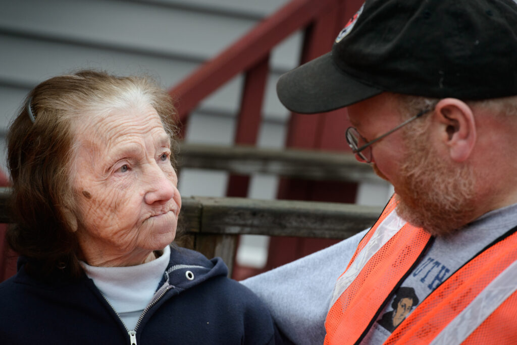 The Rev. Donald Love, pastor at Calvary Lutheran Church in Watseka, Ill., talks to Mini Kessinger, an 88 year-old flood victim and parishioner, while teams conducted a volunteer event for cleanup of flood-damaged homes on Saturday, Jan. 9, 2016, in Watseka. LCMS Communications/Erik M. Lunsford