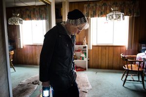 Parishioner Barb Neels of Our Savior Lutheran Church in Fenton, Mo., walks through her flood-ravaged Fenton home Jan. 7. Floodwaters overtook several communities surrounding St. Louis following intense rainstorms throughout the Midwest in late December. Neels' basement was completely submerged after floodwater breached a wall of sandbags. (LCMS/Erik M. Lunsford)