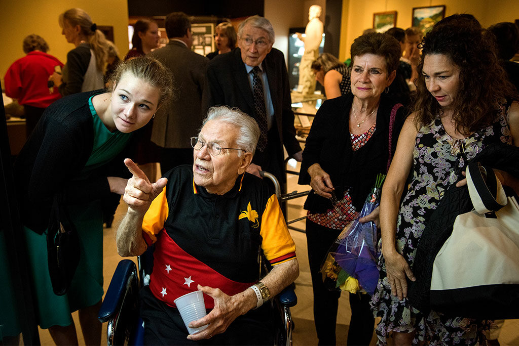 The Rev. Dr. Otto C. Hintze Jr. browses artifacts with family, including his granddaughter, Ellie Hintze (left), during the Oct. 5, 2014, opening of Concordia Historical Institute's "Bringing Christ to the Highlands" exhibit. (LCMS/Erik M. Lunsford)