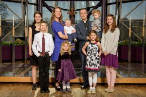 The Rev. Clint and Lalita Hoff, holding, from left, Ezra and Dietrich, pose with the rest of their children: from left, Violette, Kenneth, Bernadette, Evangeline and Cosette. (LCMS/Erik M. Lunsford)