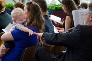 The Rev. Dr. Hans Trinklein, a missionary to South Korea, responds to young Ezra Hoff during the March 11 "Service of Sending." (LCMS/Frank Kohn)