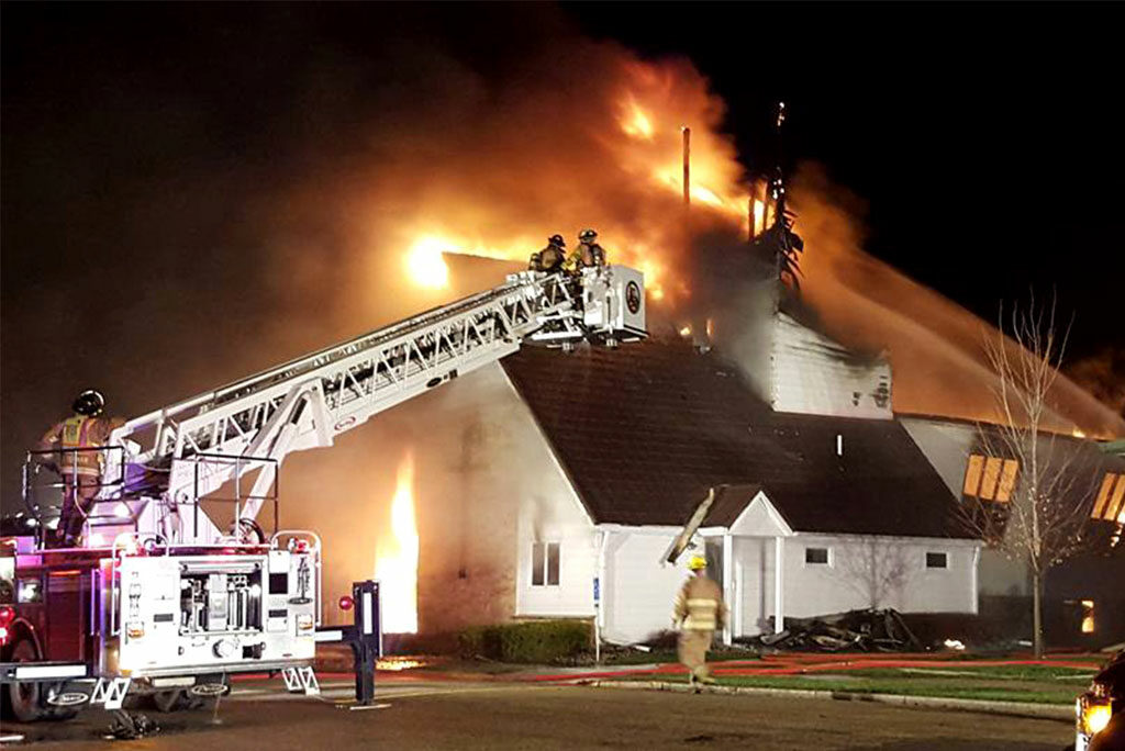 Firefighters work to bring flames under control March 30 at St. James Evangelical Lutheran Church in Northrop, Minn. Fire crews from five towns responded to the overnight fire, which was started by lightning, according to authorities. (Courtesy of The Truman Tribune)