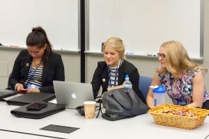 Concordia University, St. Paul students, from left, Rebecca Rust, Alexandra Van Guilder and Lydia Hook do some last-minute polishing before their presentation that earned third place in the LCEF marketing competition. (LCEF/Jay T Garrott)